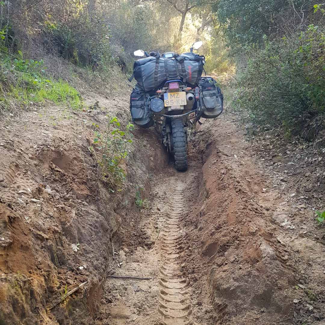 Deep ruts makes riding adventure motorcycle challenging.