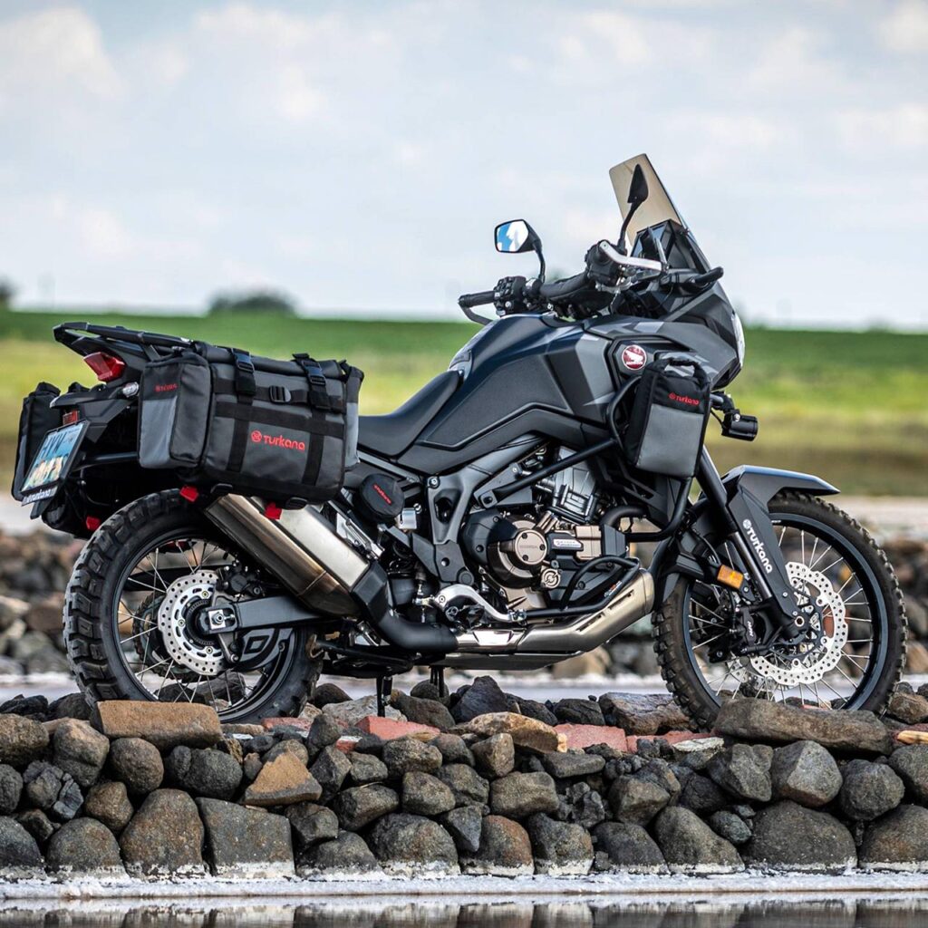 Honda Africa Twin motorcycle with Turkana HippoHips saddlebags and BushBaby bags mounted to the crash bar.