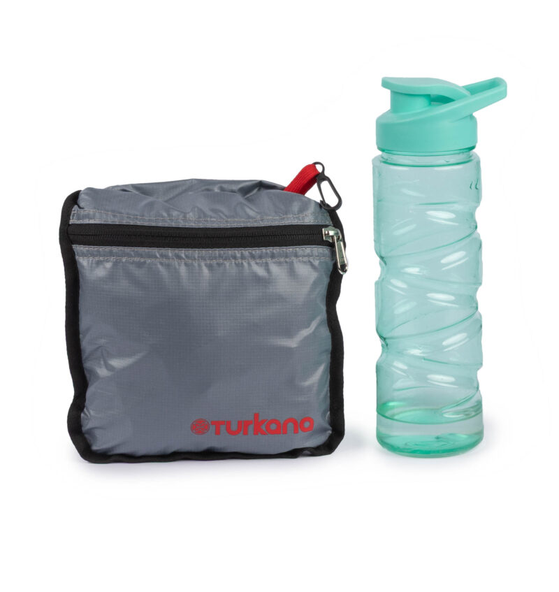 YakSak 15L folded into its zip pouch next to a 750 ml water bottle for size comparison.