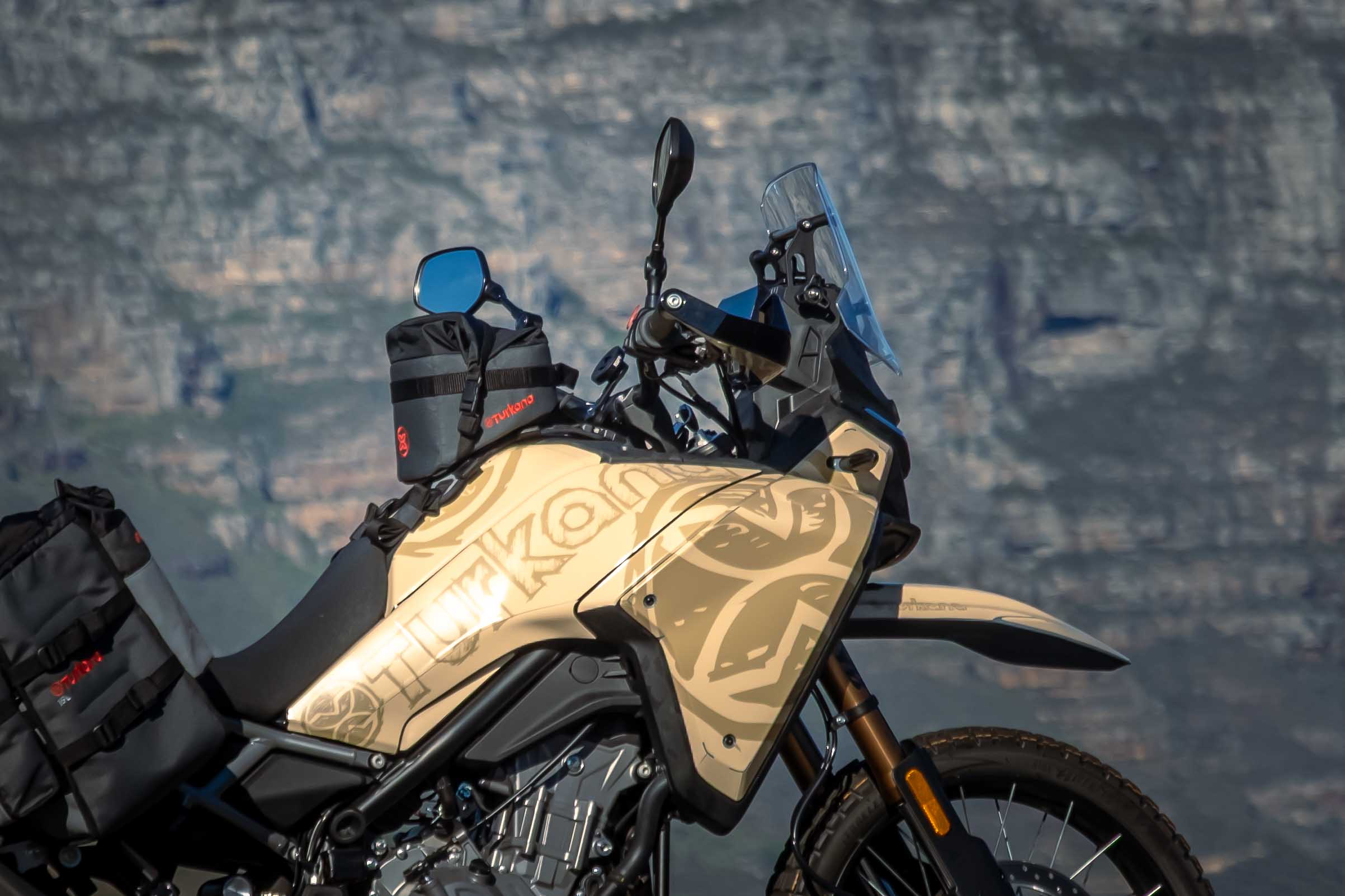 Bullfrog™ 5L tank bag mounted on the CFMoto450 motorcycle with GeckoGrip™ harness by Turkana Gear