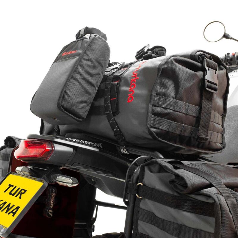 Turkana Duffalo duffel bag mounted on a motorcycle with a BushBaby bag attached for extra storage.