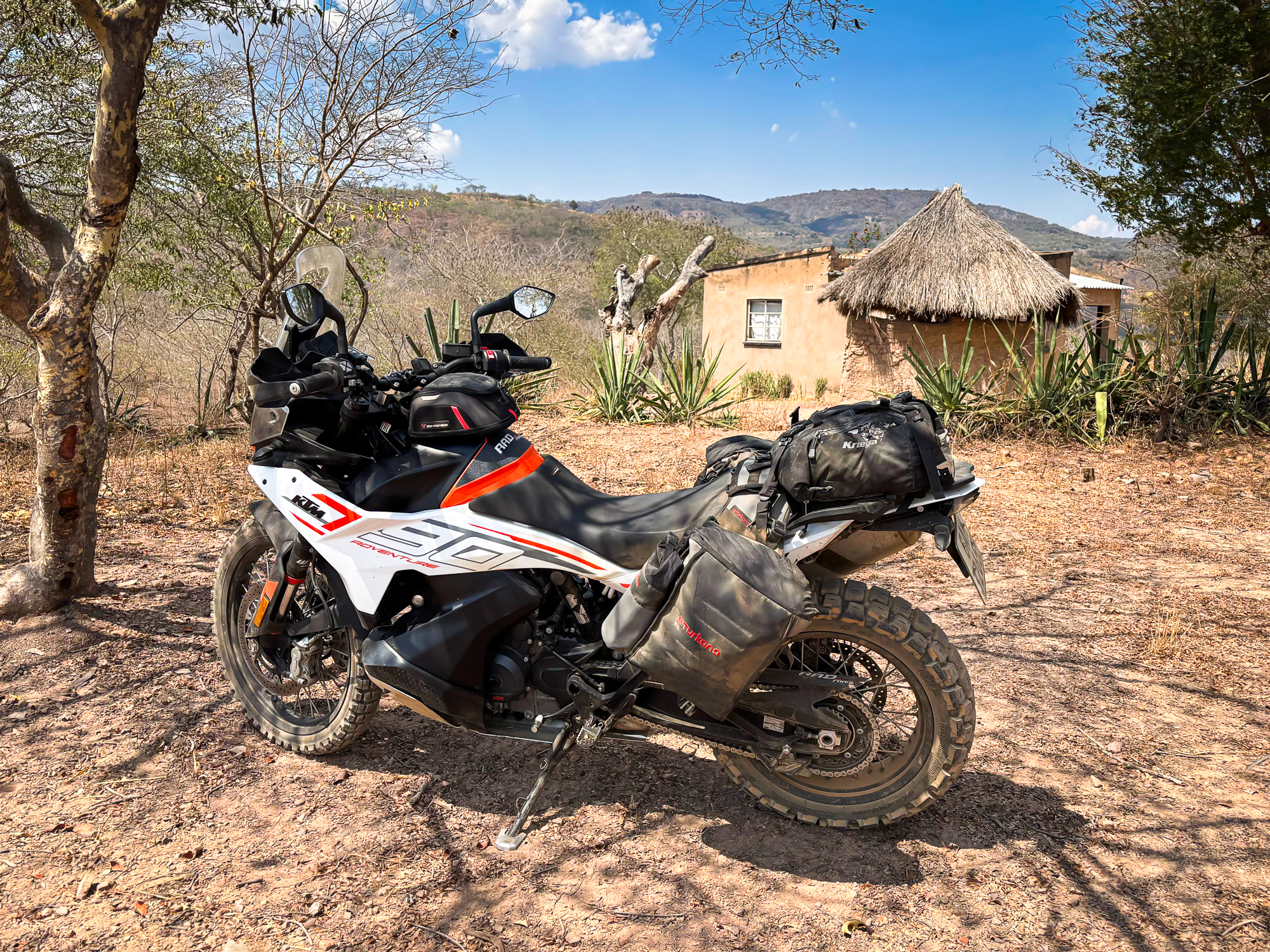 Crossing into the unknown — a KTM 790 Adventure kitted with Turkana Gear Mad Mules makes every rural gate a step deeper into Zimbabwe’s wild roads.