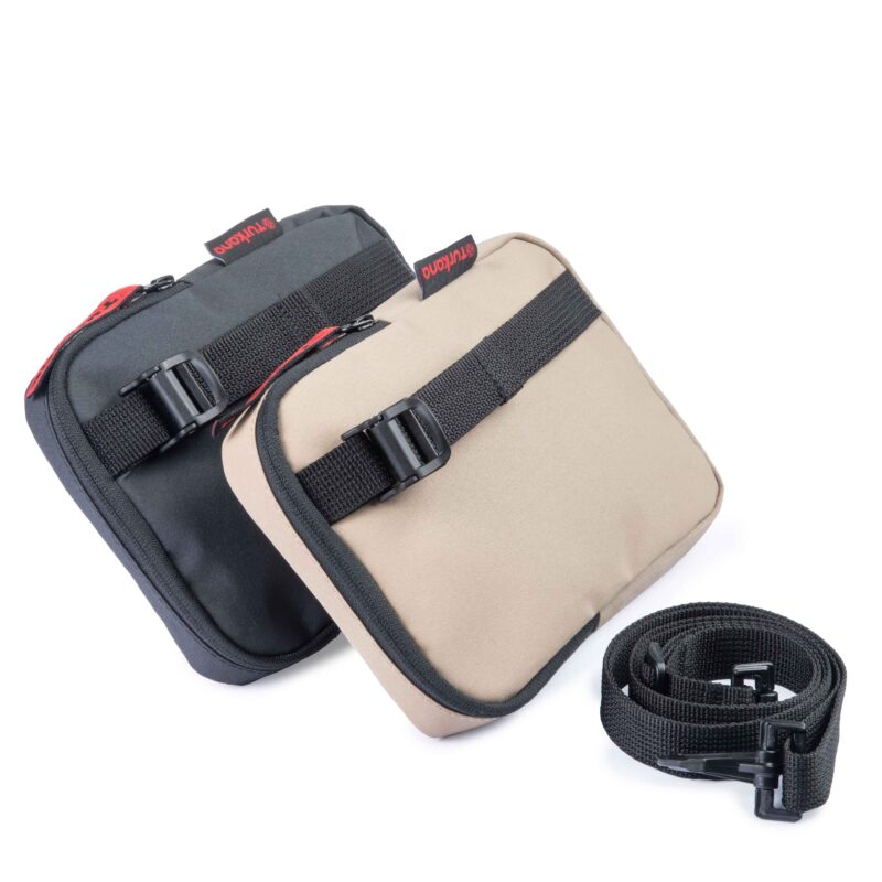 Front angle of black and sand Turkana SlingThing pouches showing the cam buckle attachment strap.