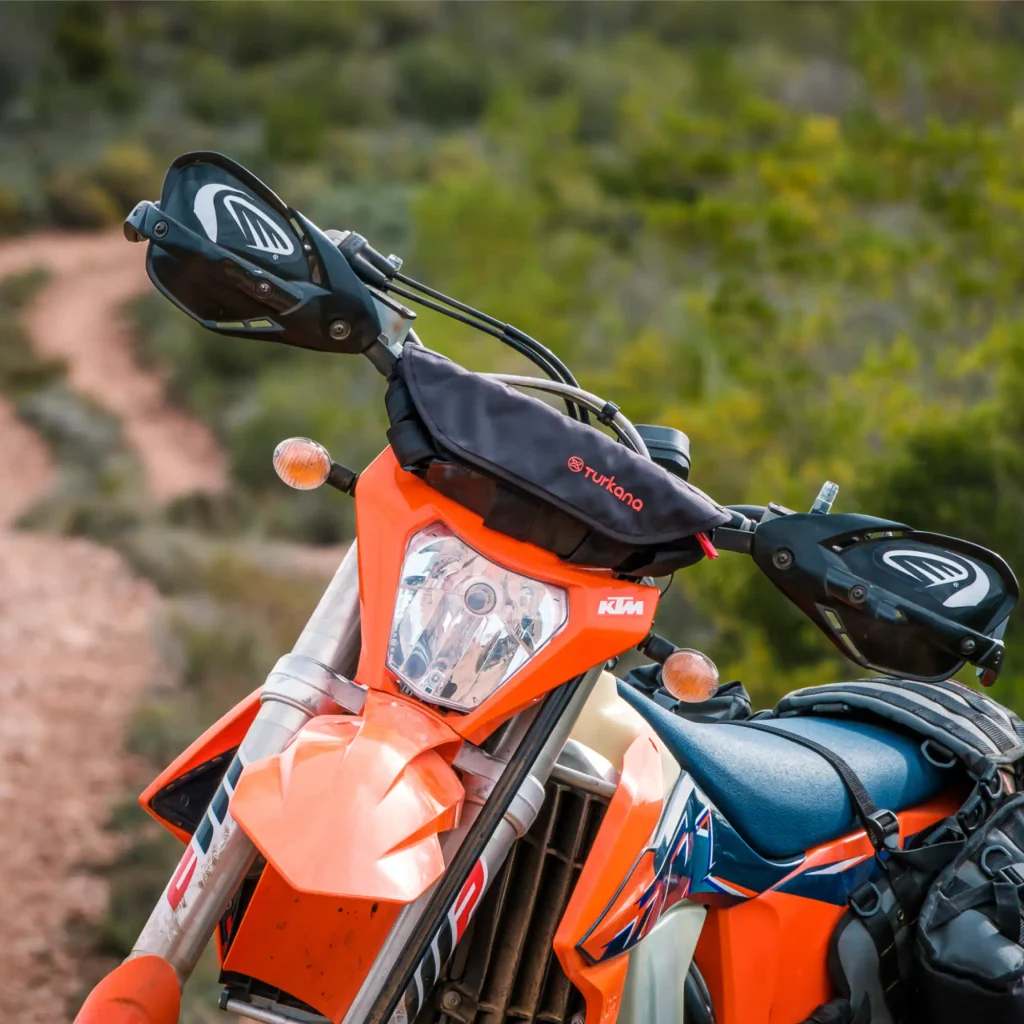 Turkana PelliPouch Enduro fitted to the low-sweep handlebars of an orange KTM enduro motorcycle.