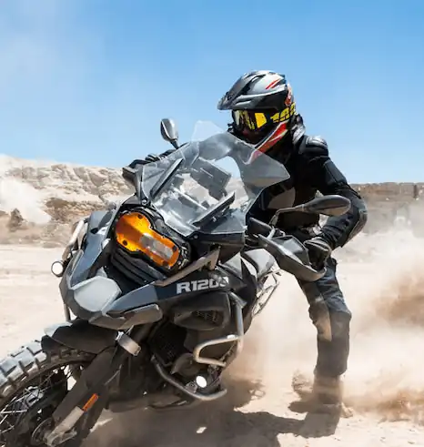 Adventure motorcyclist tackling rugged off-road terrain