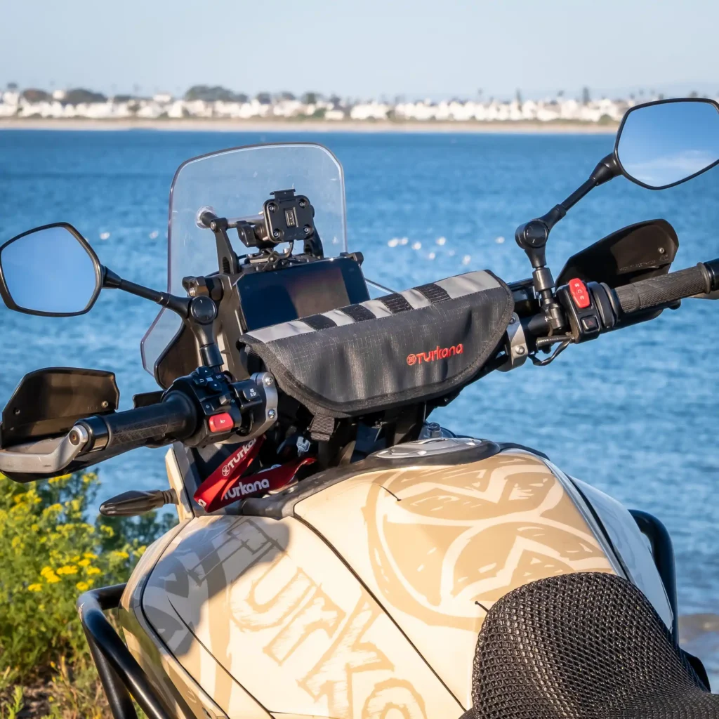 Turkana PelliPouch Enduro mounted across an adventure motorcycle’s handlebars.