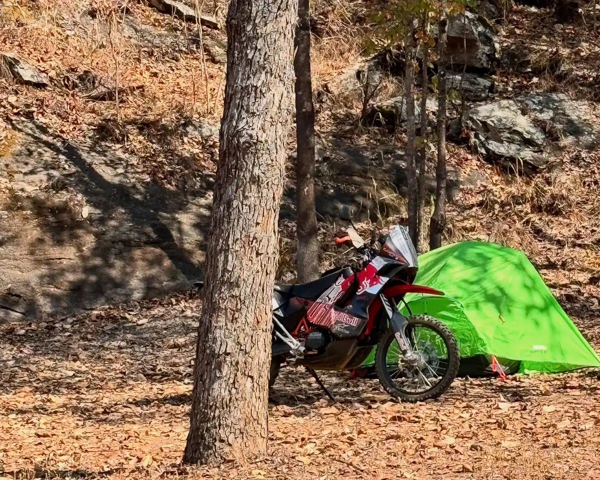 KTM 690 Enduro parked beside a tent during Tagore Sureshbabu's motorcycle journey through Africa